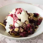 Bowl of Mixed Berry Crumble over ice cream