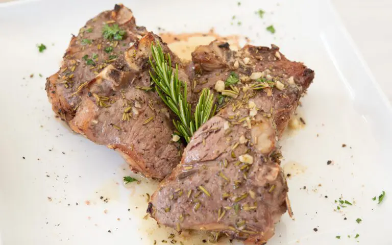 Lambchops marinated in garlic and rosemary on a white plate