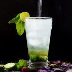 Sparkling Water being poured into a Lavender Mojito