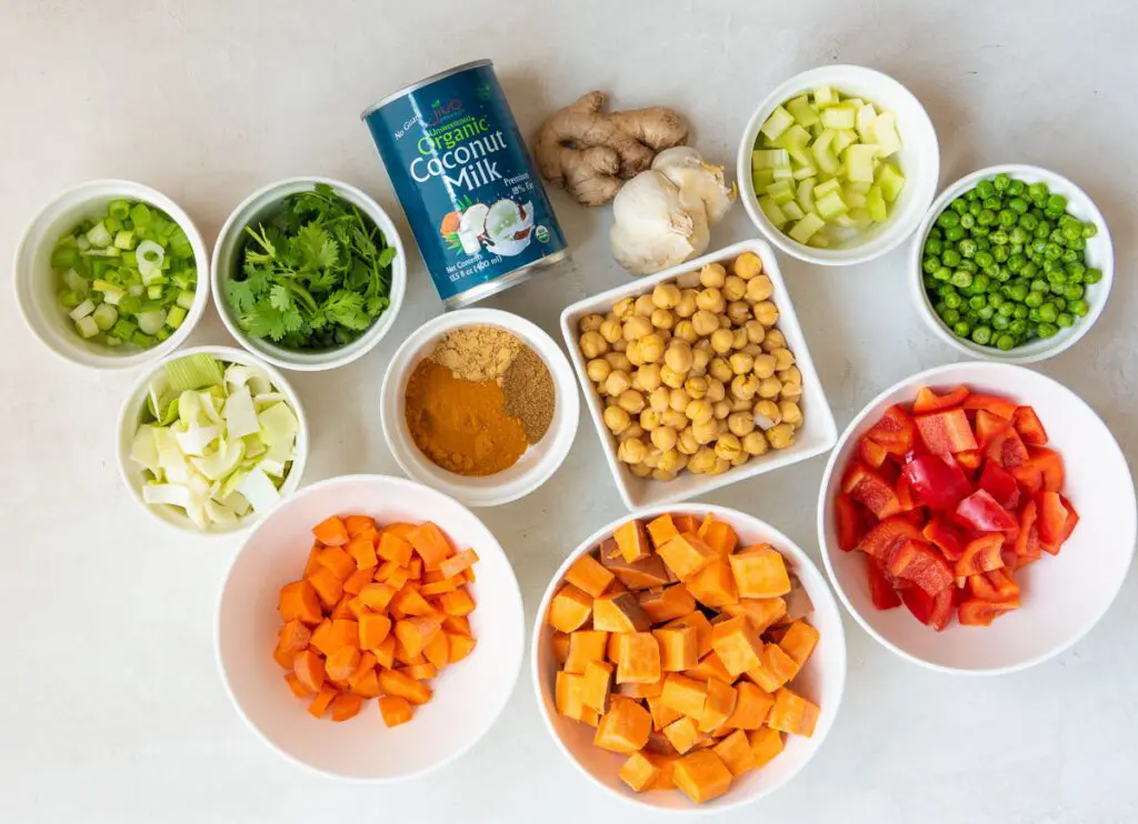 Sweet Potatoes, Leeks, Red Pepper, Carrots, Garlic and other Curry Spices on a Table
