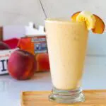 Peach Smoothie with a crate of fresh peaches