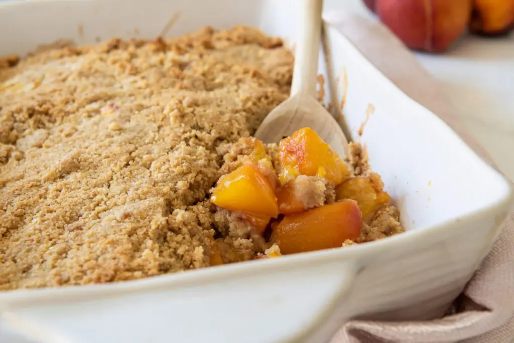 Large white pan of Gluten-Free Peach Crisp