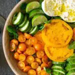 Heirloom Tomatoes with Bright Green Vegetables in a wooden bowl