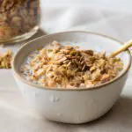 Golden Homemade GF Granola in a Bowl with Milk