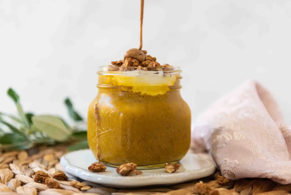 Small Mason Jar filled with Pumpkin Chia Pudding and drizzled with Almond Butter