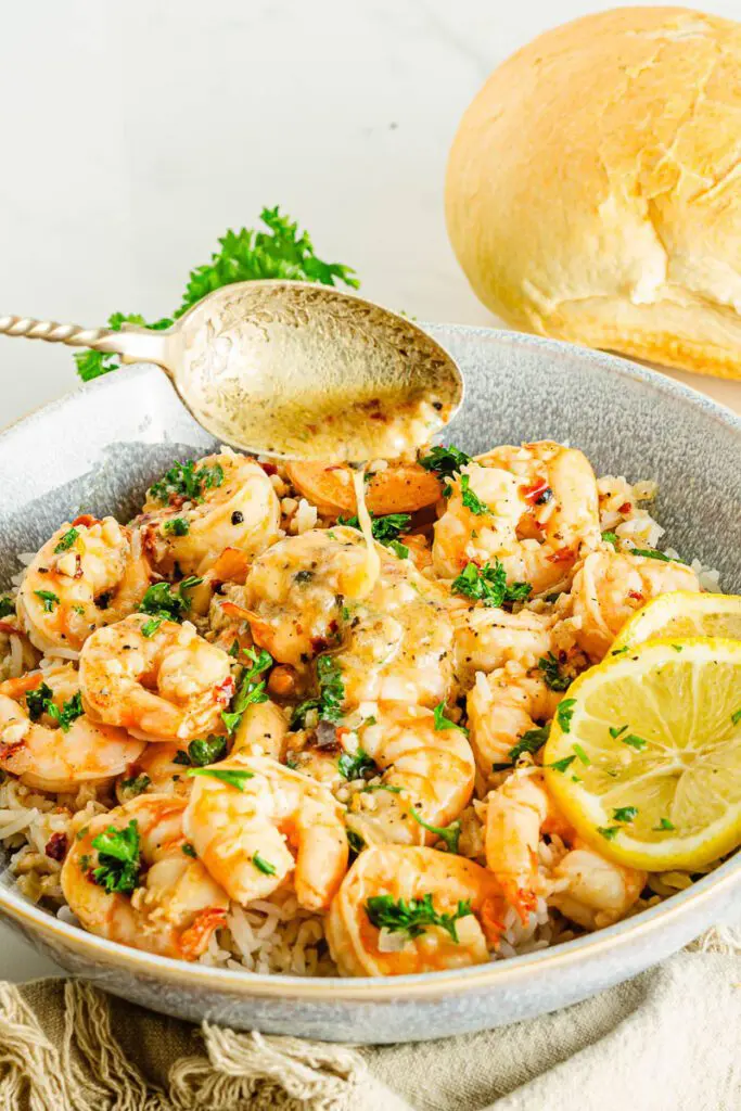 Adding butter and lemon to shrimp scampi