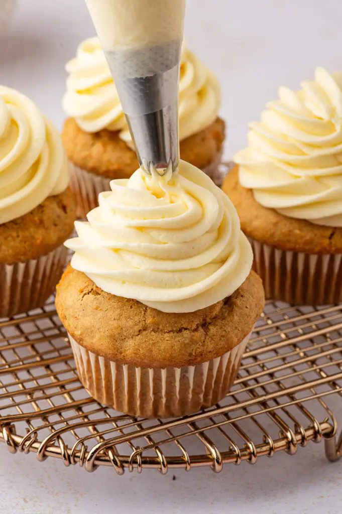 Pipe Buttercream onto Gluten-Free Carrot Cupcakes