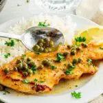 Spoon sauce over gluten-free chicken piccata.