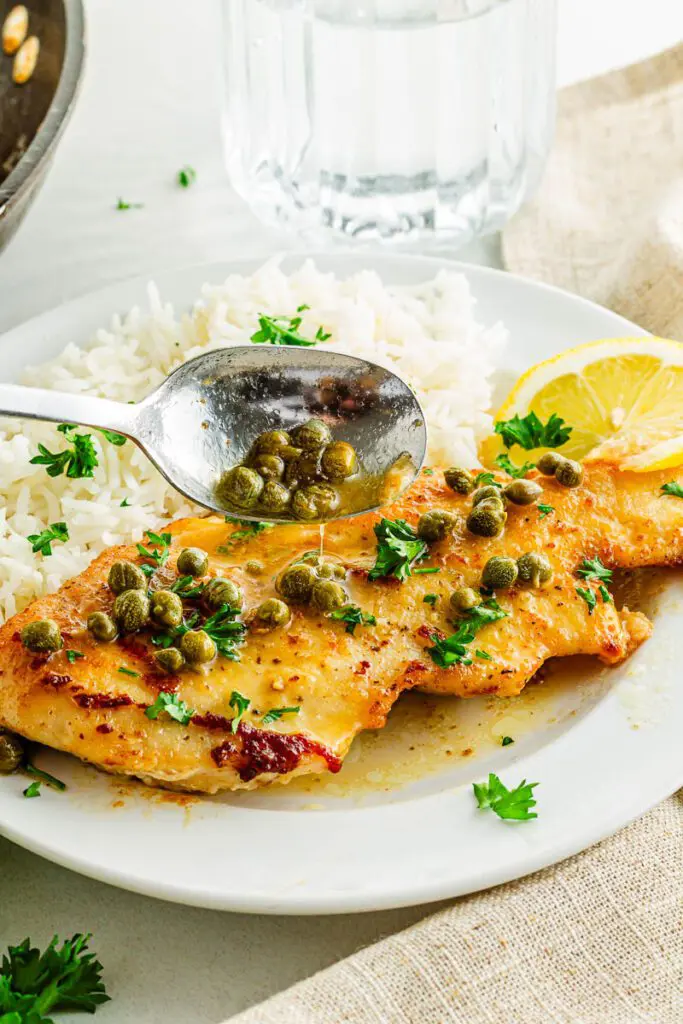 Spoon sauce over gluten-free chicken piccata.