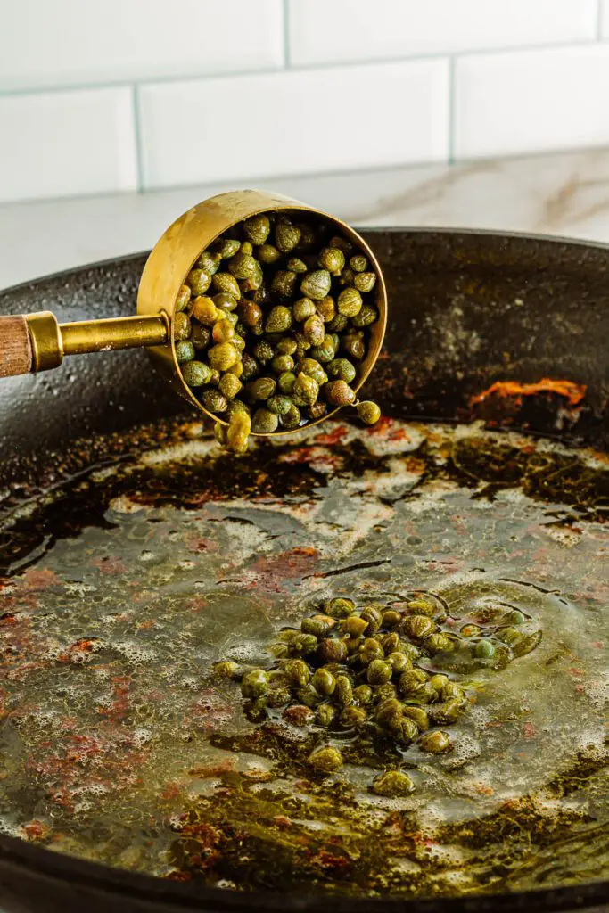 Add capers to hot pan.