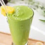 Glass of green avocado pineapple smoothie