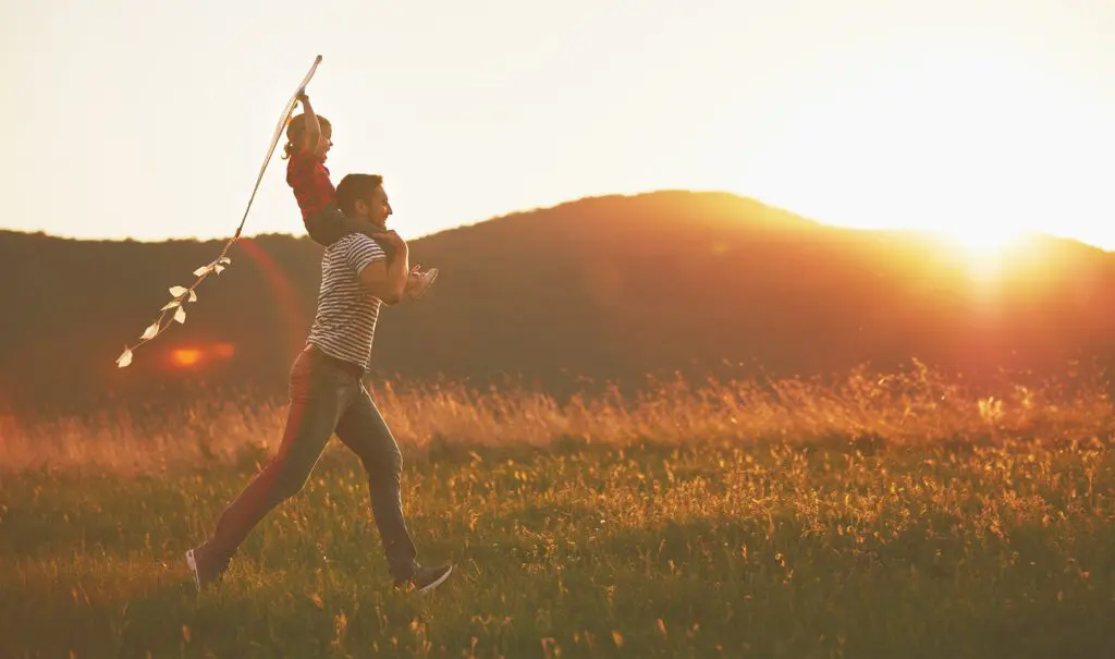 Man running with child with flax