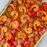 Spread shrimp and sausage onto a sheet pan