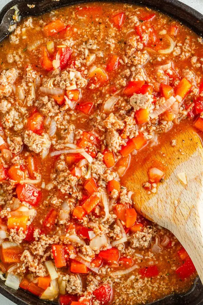 Mix tomatoes and peppers with turkey skillet