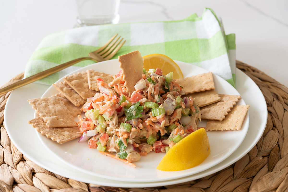 Salmon Salad on a white plate with crackers and lemon 