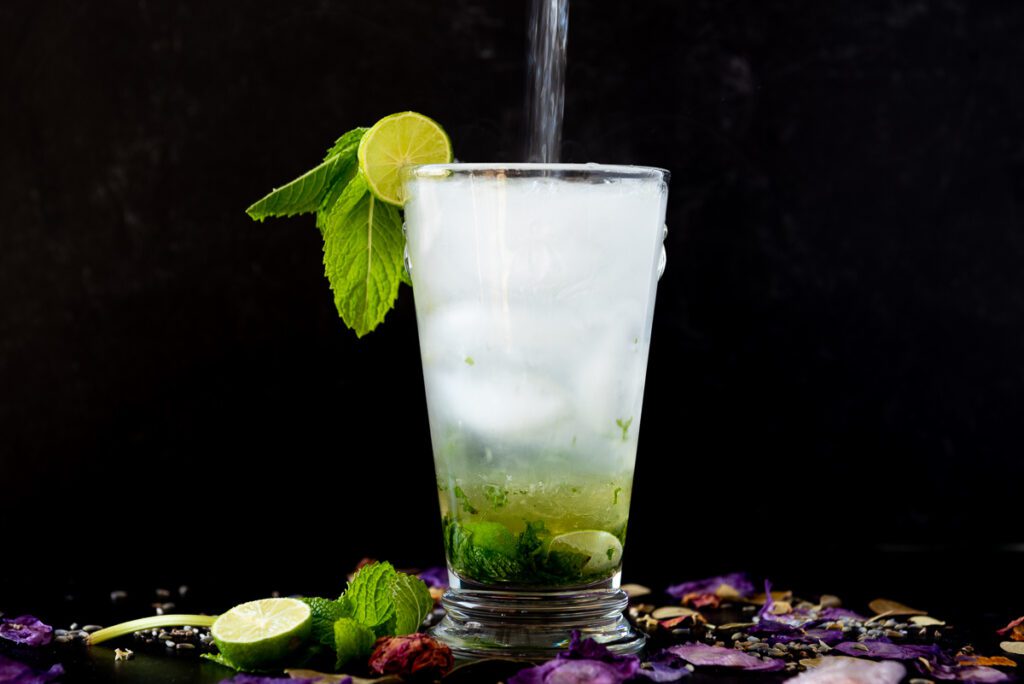 Sparkling Water being poured into a Lavender Mojito 