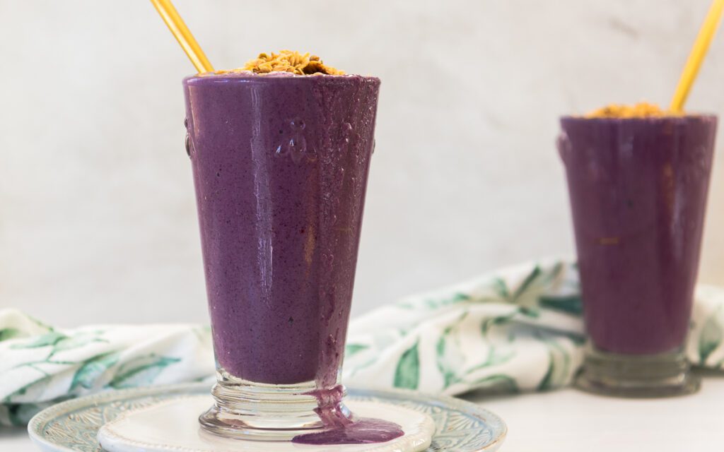 Blueberry Smoothie with Granola in Tall Glass 