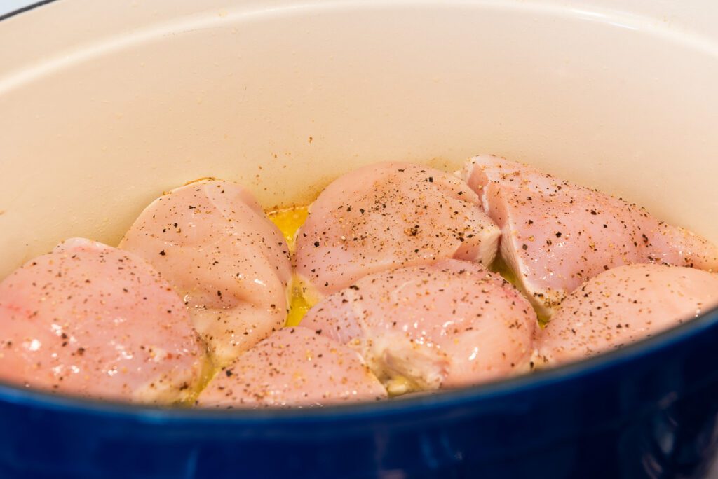 Chicken Breasts Cooking in Large Blue Pot