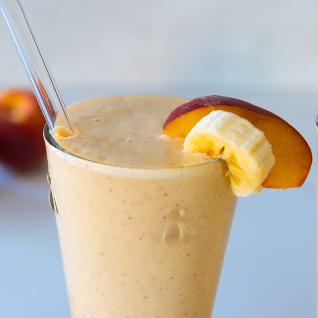 Peach Smoothie with a slice of Peach and a Slice of Banana 