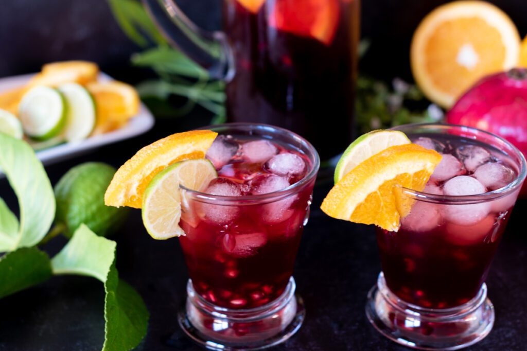 Two Glasses of Pomegranate Cocktail with fresh fruit