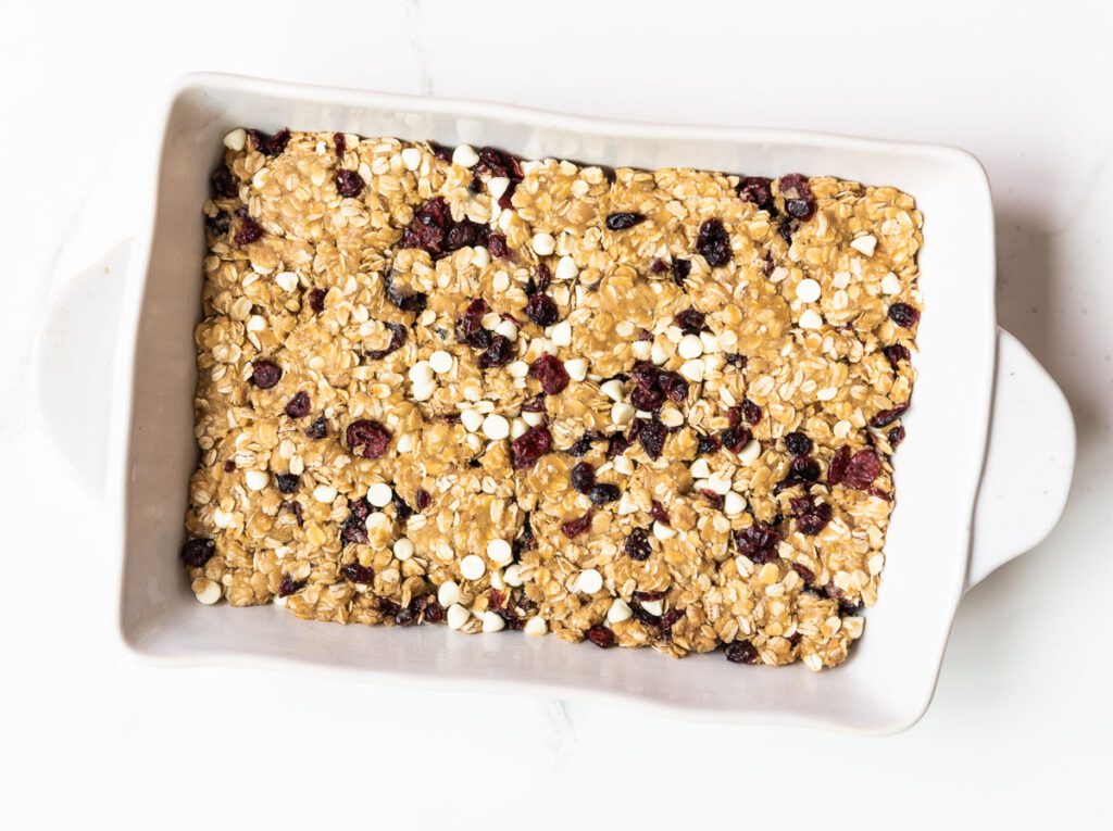 Press White Chocolate Chip Cranberry Oatmeal Cookie Dough into 9x13 Baking Pan 
