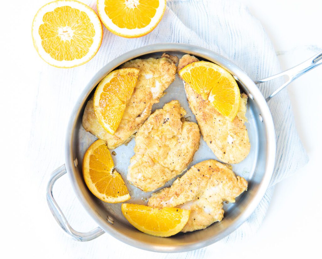 Chicken cooked in pan with oranges 