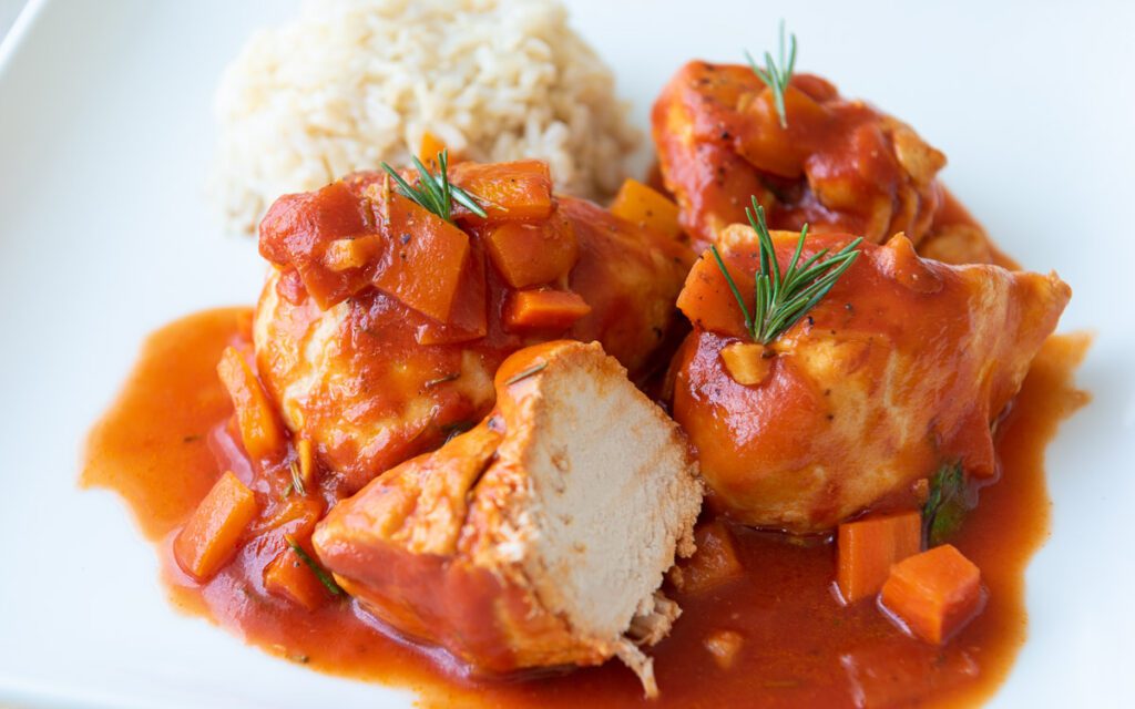 Chicken Cacciatore on plate with rice 