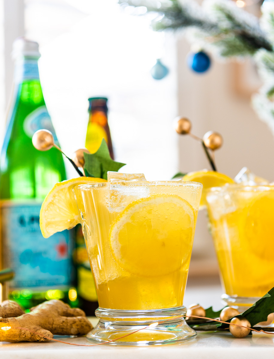 Ginger Mocktail with Bottles behind it and Christmas Decorations 