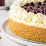 Large gluten-free cheesecake with whipped cream