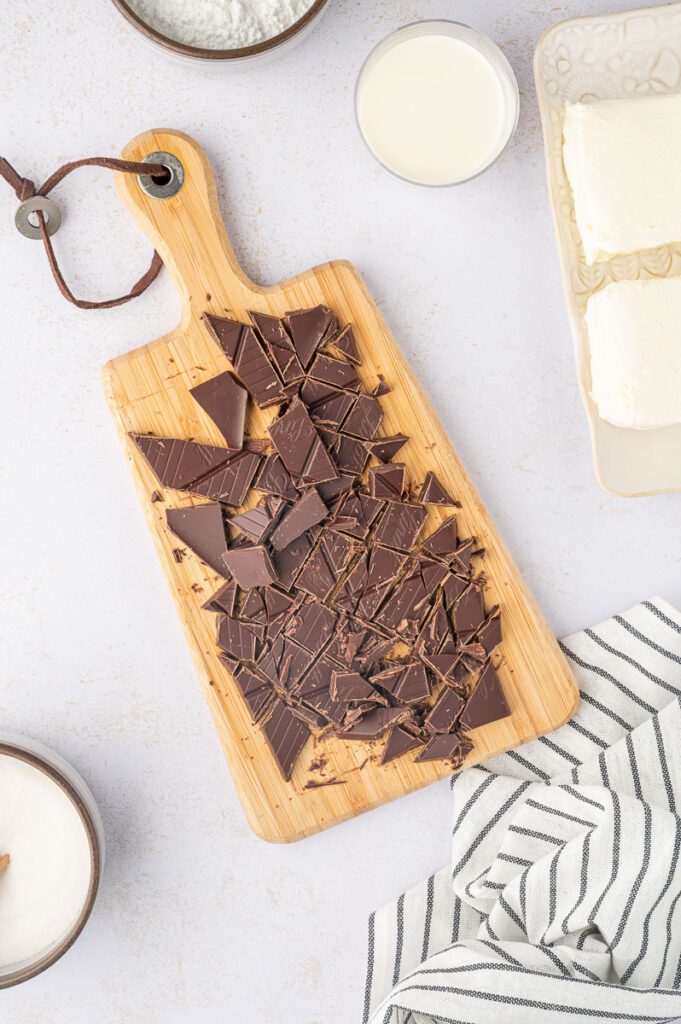 Chopping dark chocolate on cutting board