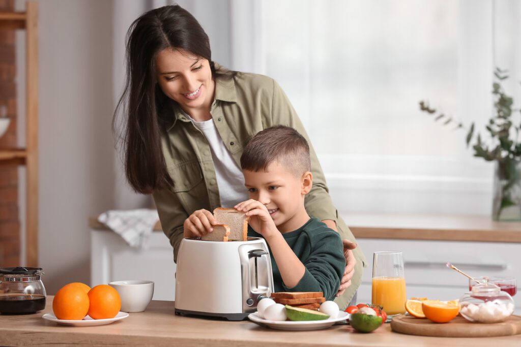Boy using toaster with mother in Celiac Safe Kitchen 